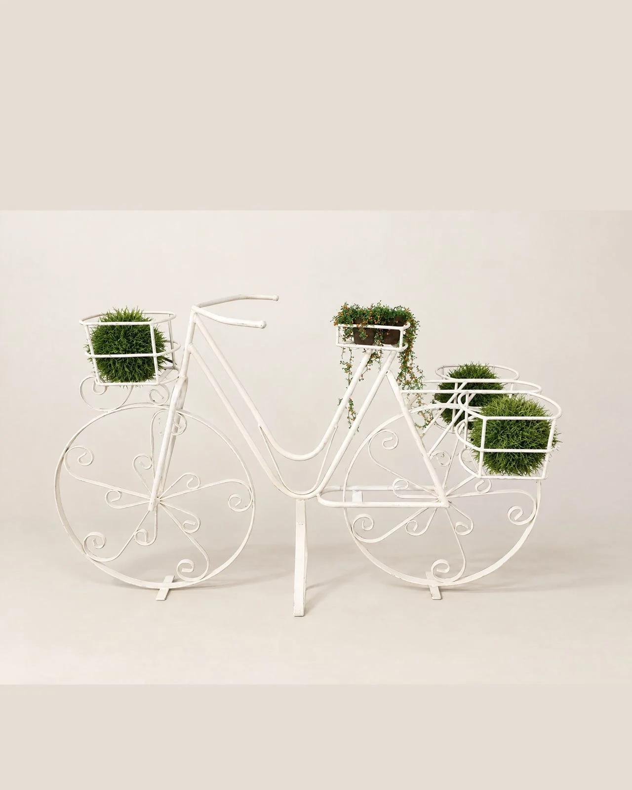 White decorative bicycle with plant pots