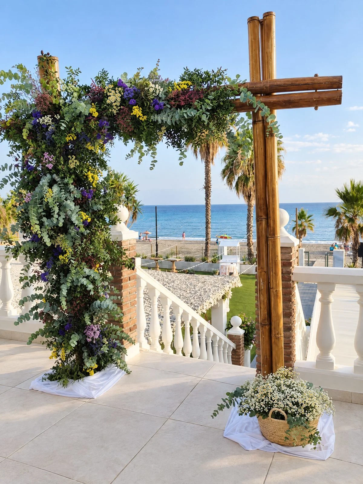 Arch of purple and yellow wildflowers beside a wooden cross, with the sea behind