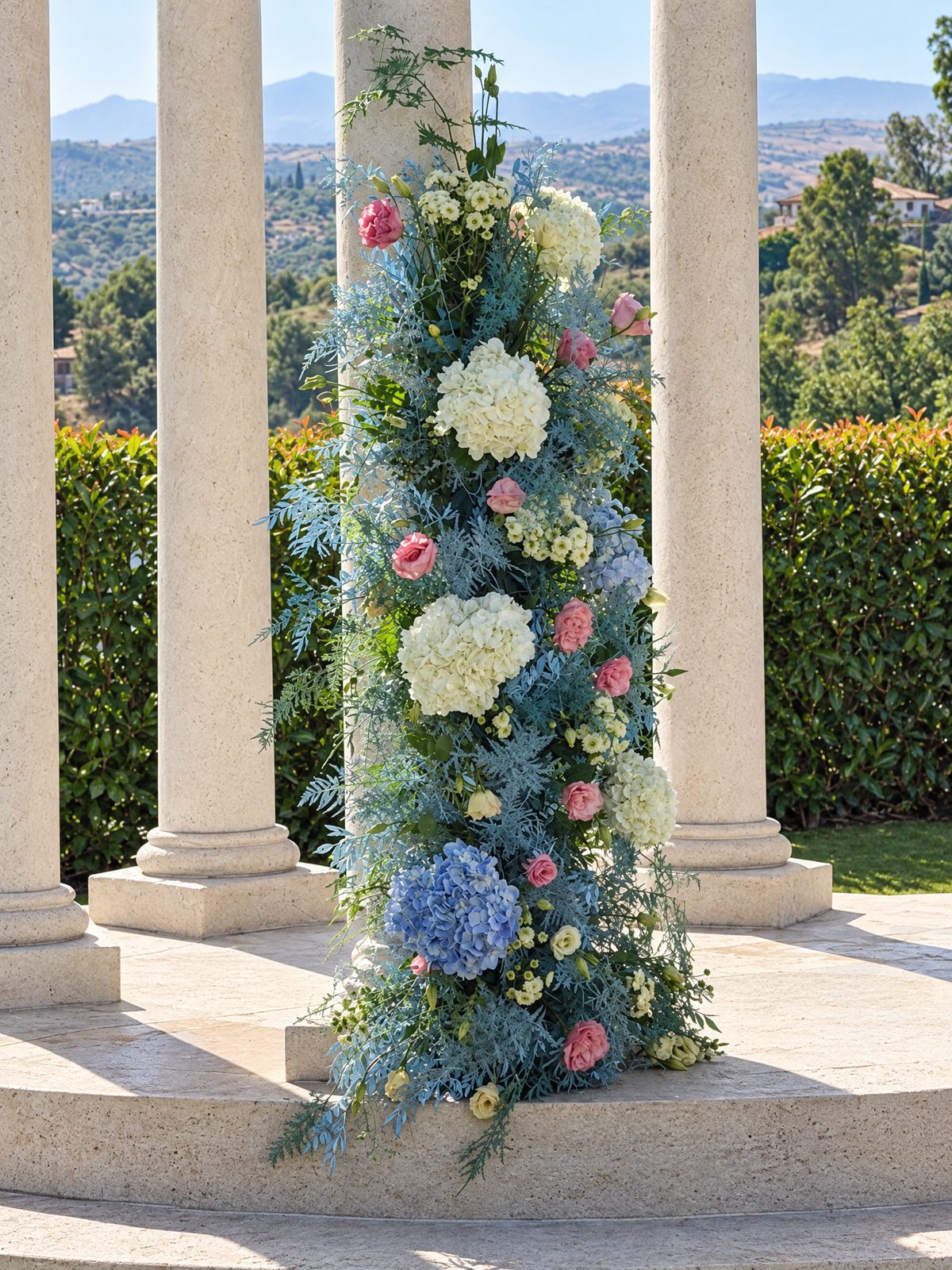 Column covered in blue and white hydrangea with roses