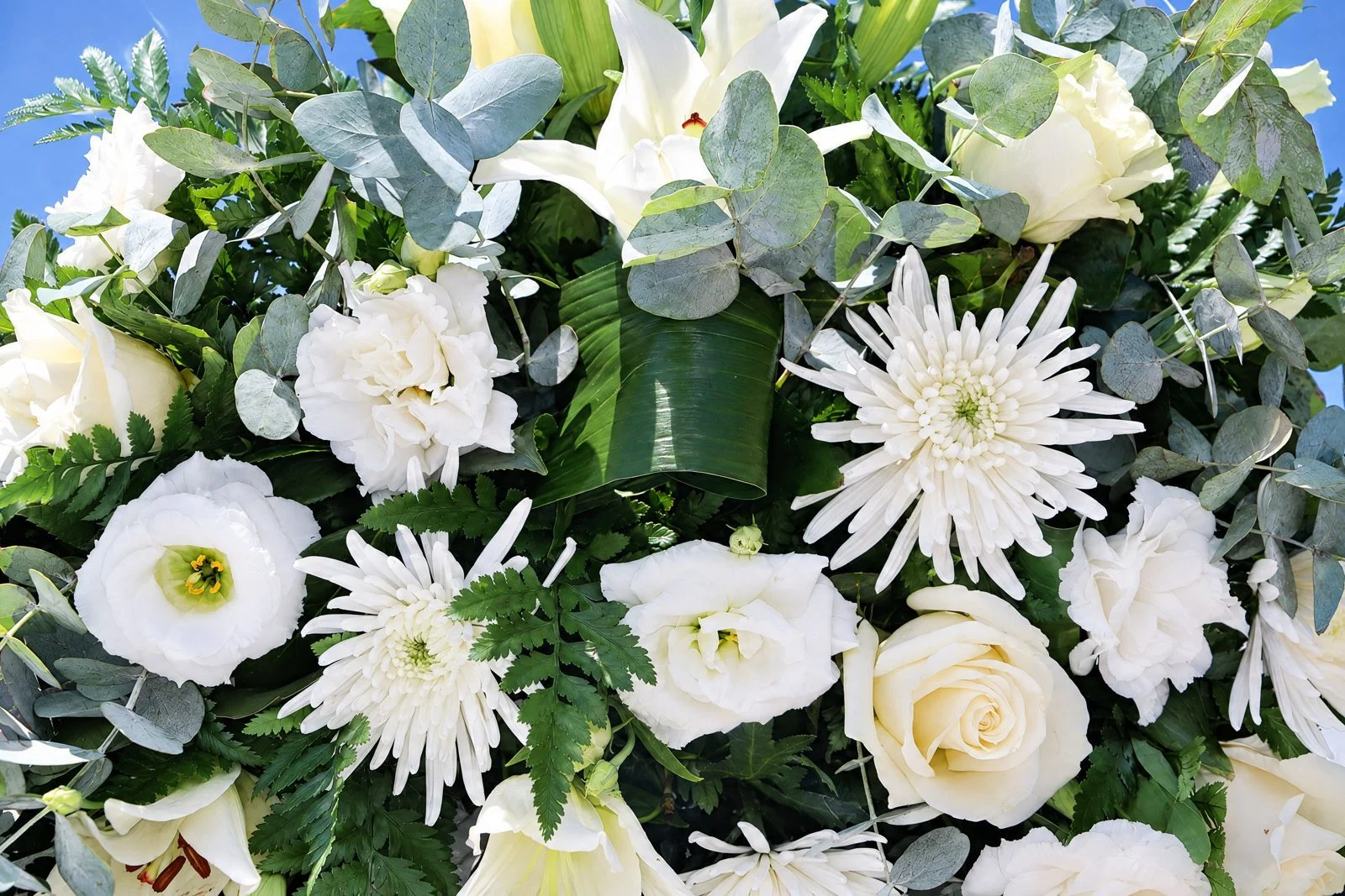 Close-up of white roses, lilies, lisianthus and chrysanthemums