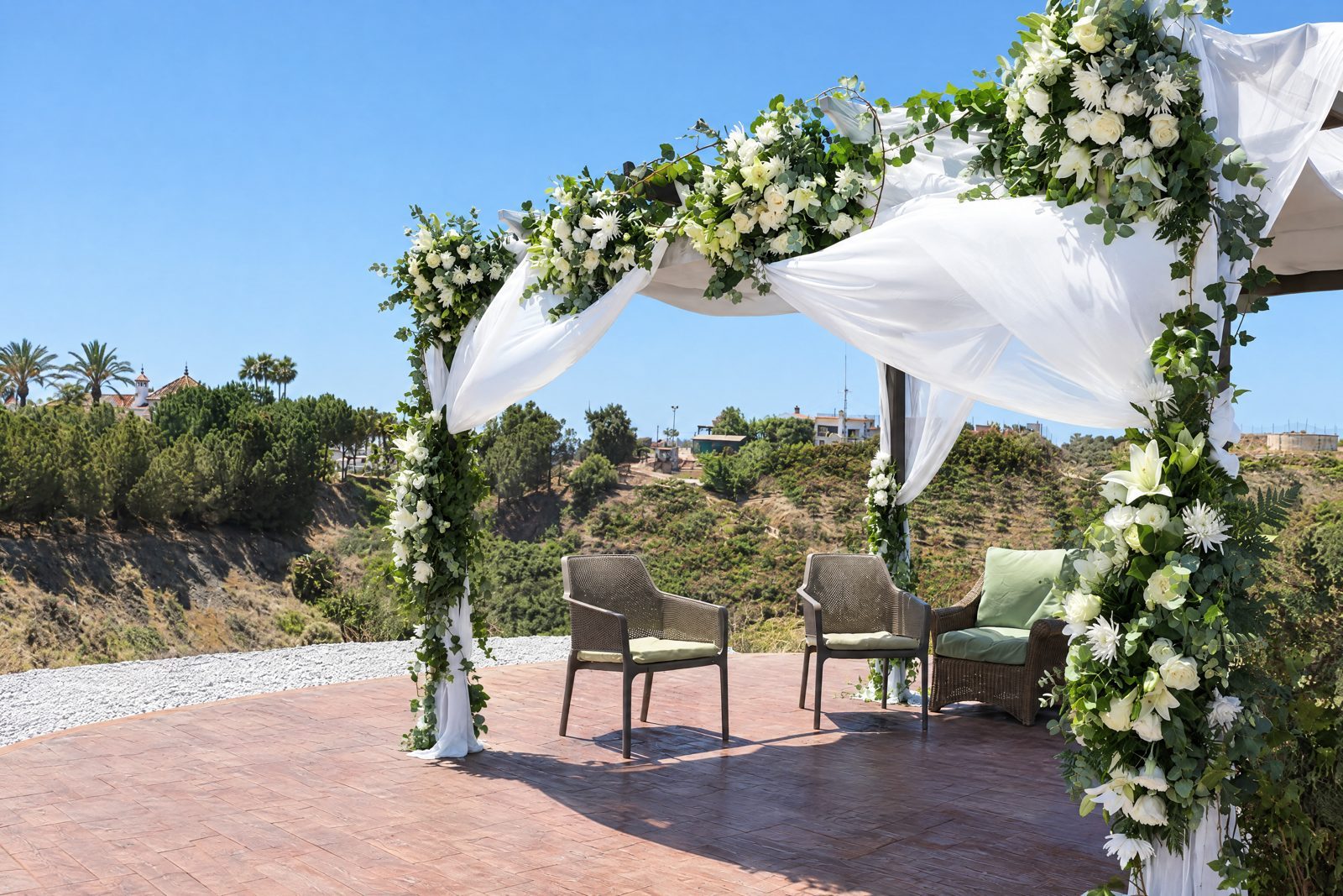 Pergola of white flowers and tulle with the mountains behind